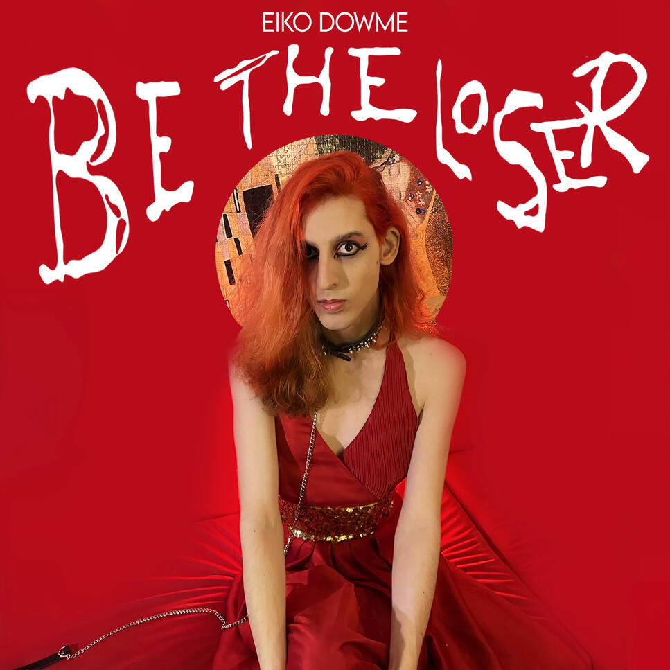 BE THE LOSER Eiko Dowme in a red dress, sitting on a red sofa in front of a red background, wearing a leash. Behind her, a small "halo" circle of Gustav Klimt's painting "the kiss" and the text BE THE LOSER in big, distorted, white letters.
